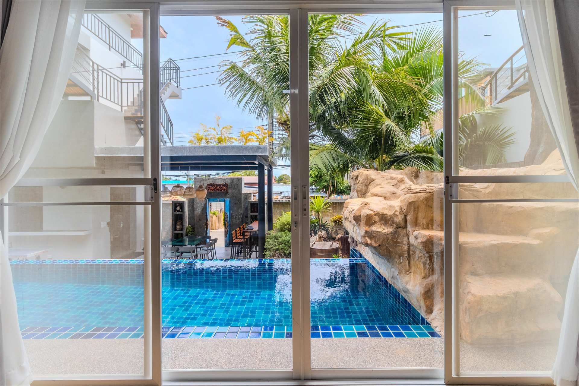 Poolside lounge with sun beds and ambient lighting